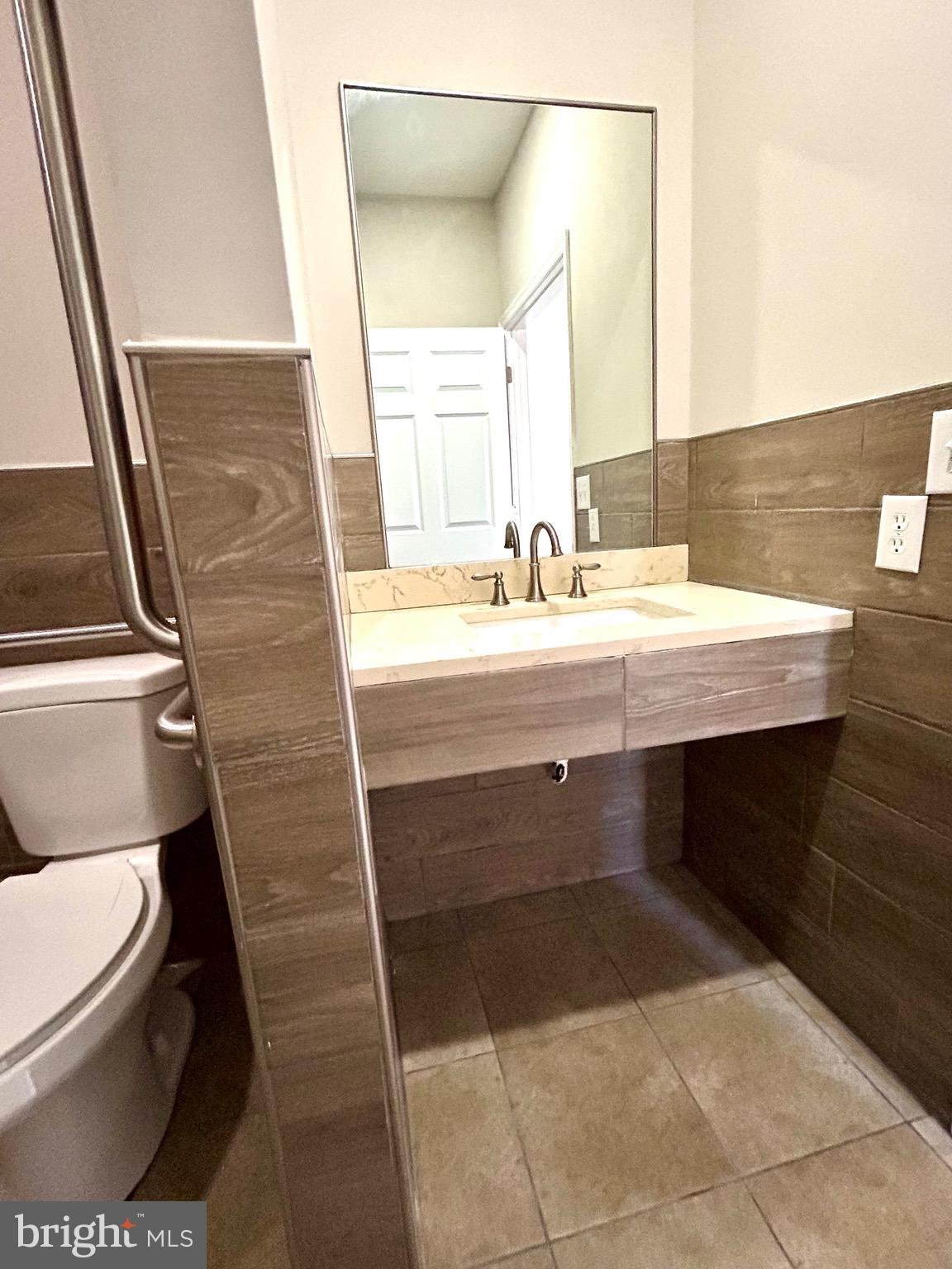 12003 Piscataway Road Clinton, MD 20735 - Photo 21 of 68 a bathroom with a sink and a mirror
