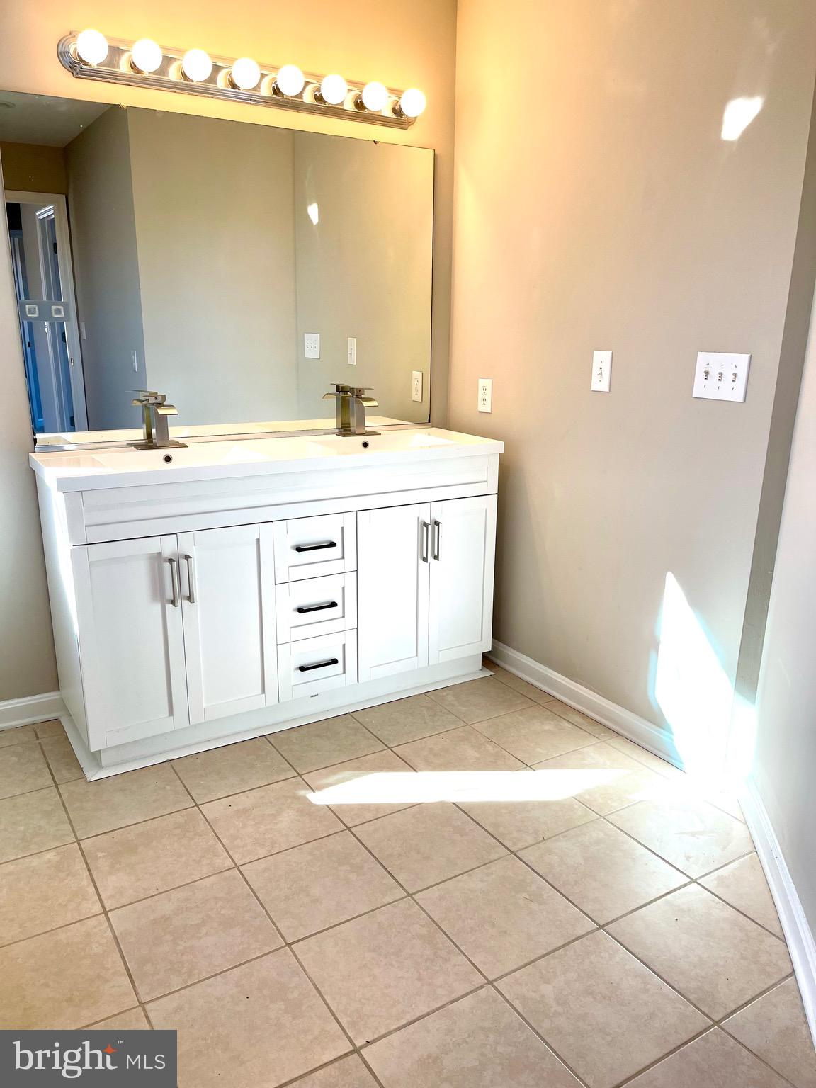 12003 Piscataway Road Clinton, MD 20735 - Photo 34 of 68 a bathroom with a sink a vanity and a mirror