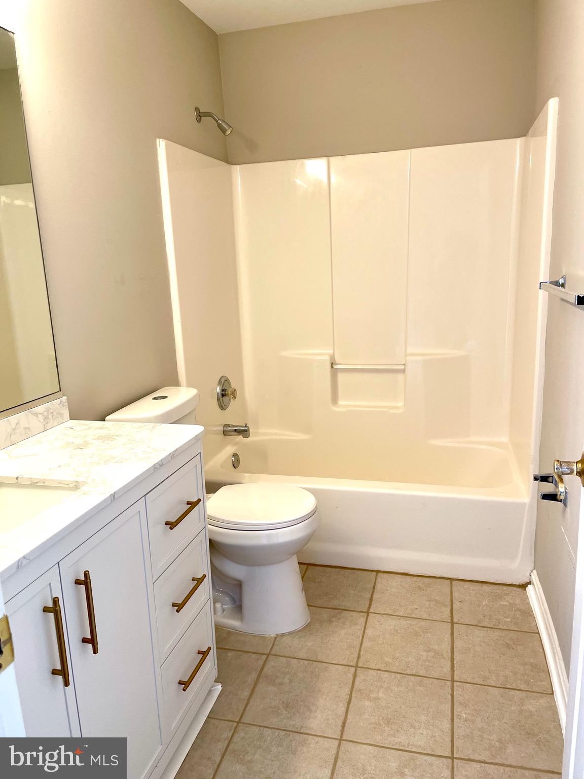 12003 Piscataway Road Clinton, MD 20735 - Photo 37 of 68 a bathroom with a granite countertop bathtub sink vanity mirror and toilet
