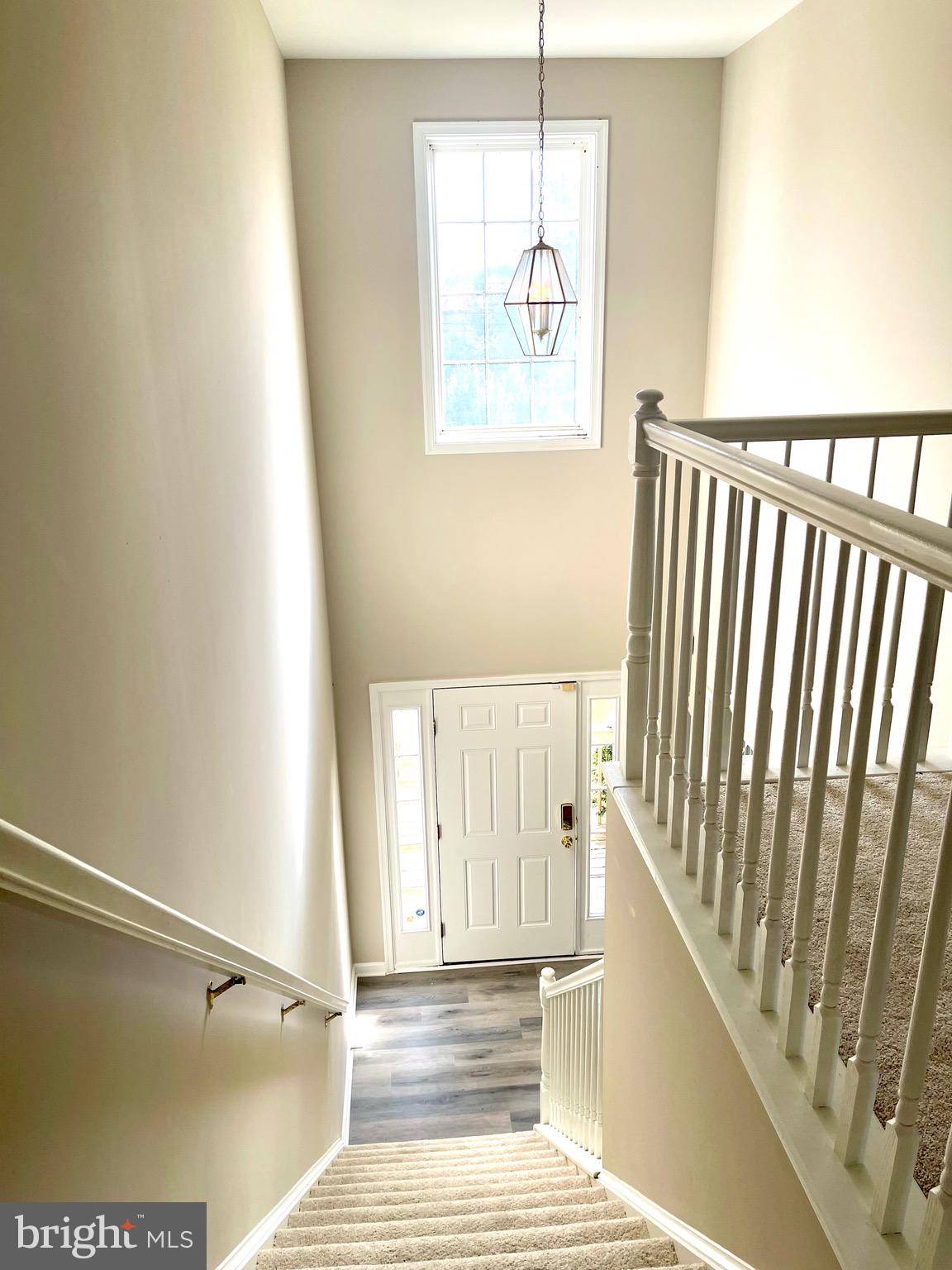 12003 Piscataway Road Clinton, MD 20735 - Photo 43 of 68 a view of a hallway with wooden floor and staircase