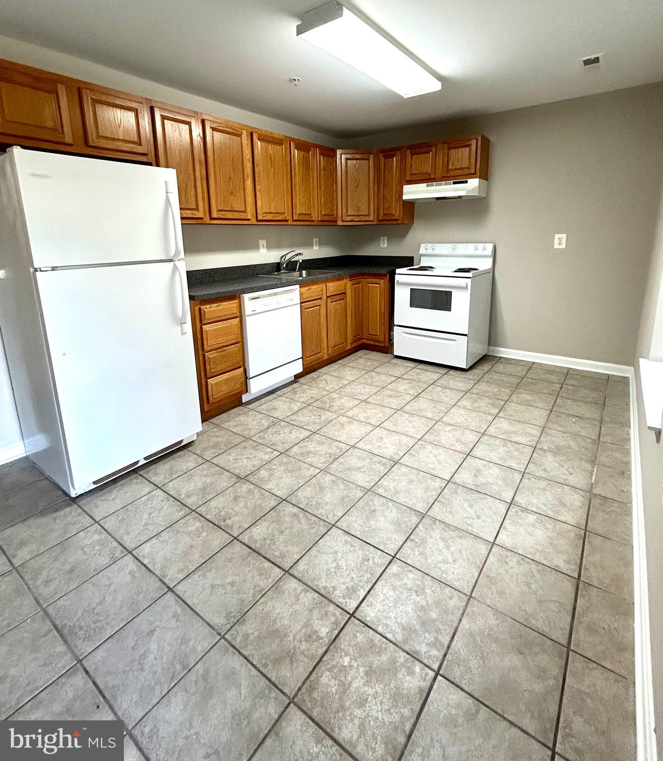 12003 Piscataway Road Clinton, MD 20735 - Photo 50 of 68 a kitchen with stainless steel appliances granite countertop a refrigerator sink stove and cabinets