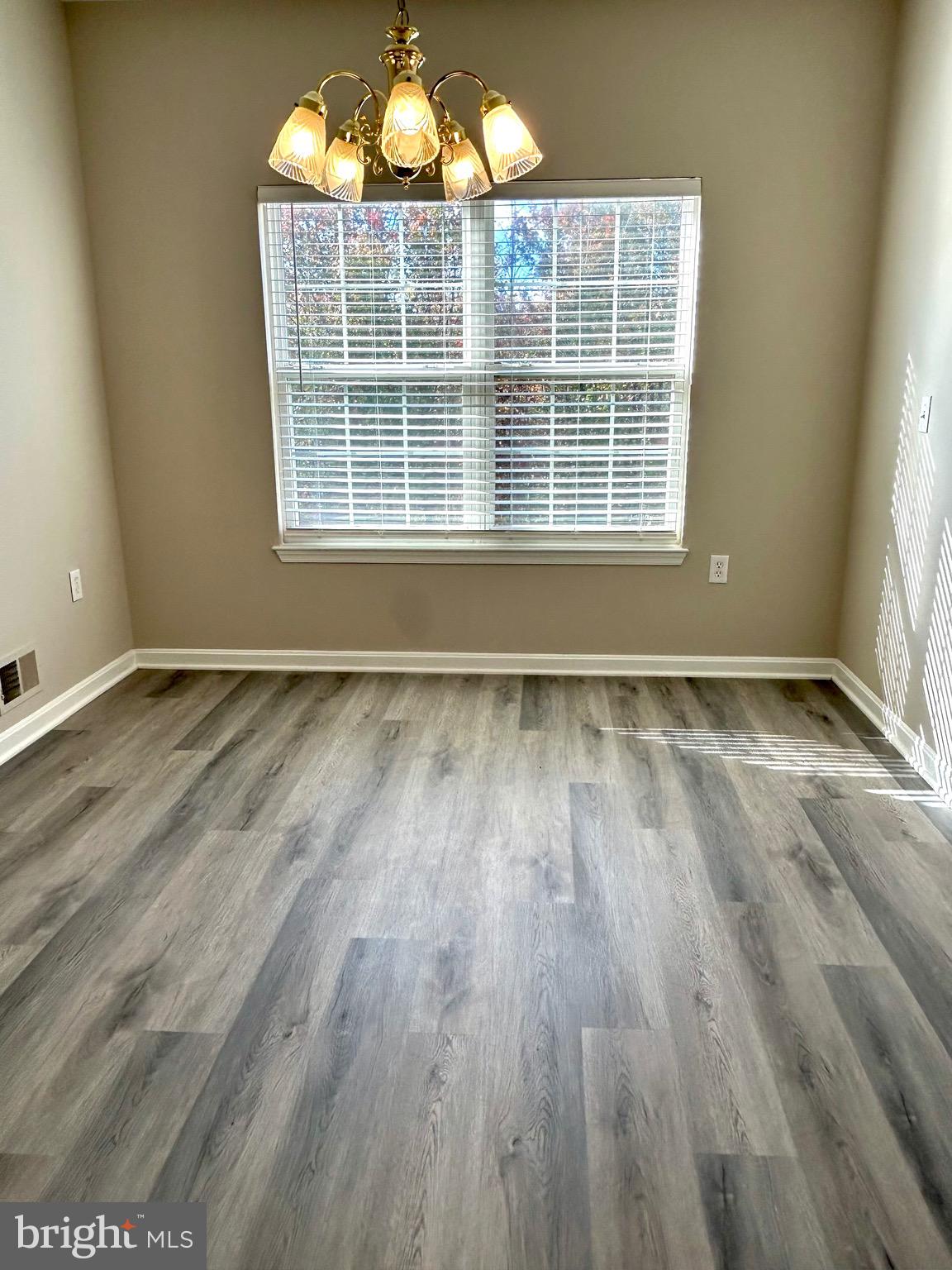 12003 Piscataway Road Clinton, MD 20735 - Photo 54 of 68 an empty room with wooden floor and windows