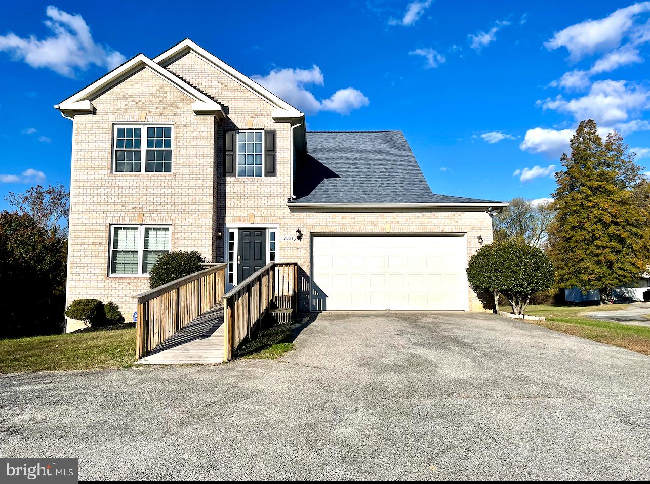 12003 Piscataway Road Clinton, MD 20735 - Photo 62 of 68 a view of a house with a yard and potted plants