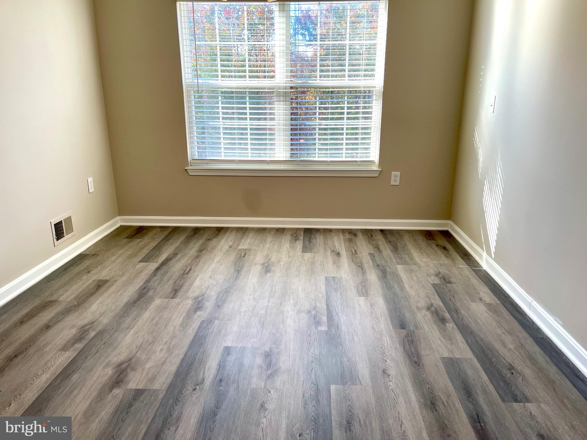 12003 Piscataway Road Clinton, MD 20735 - Photo 66 of 68 a view of an empty room with wooden floor and a window