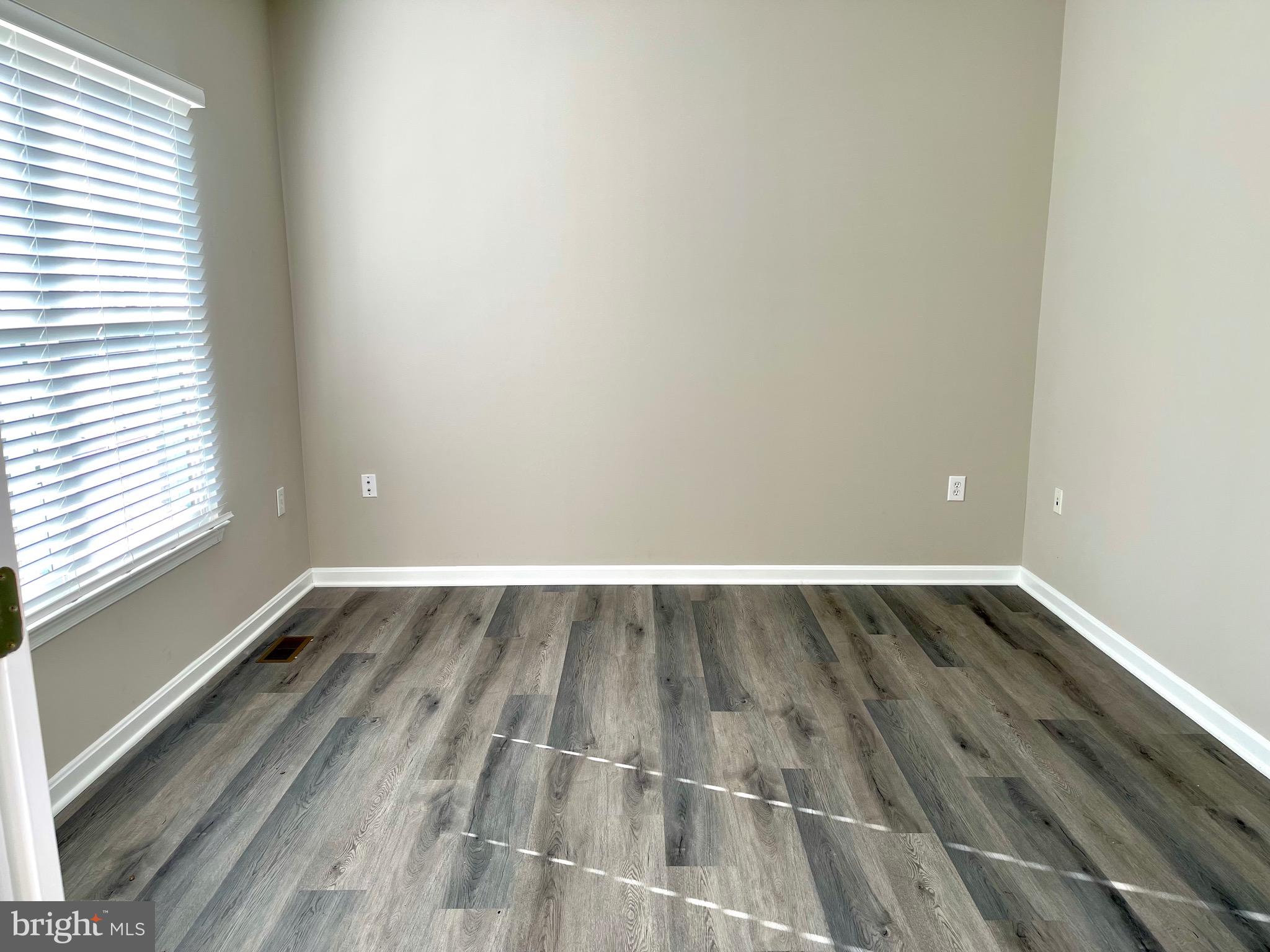12003 Piscataway Road Clinton, MD 20735 - Photo 67 of 68 a view of an empty room with wooden floor and a window