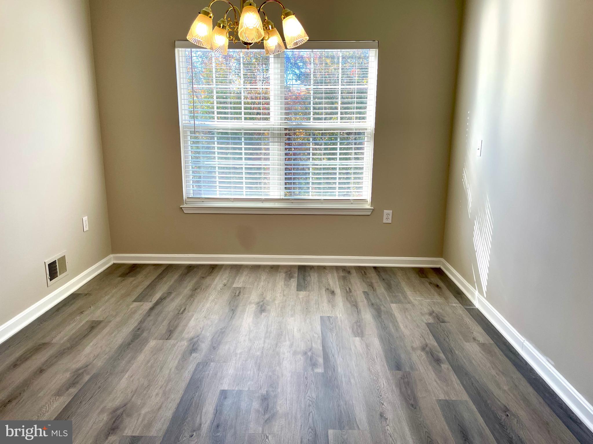 12003 Piscataway Road Clinton, MD 20735 - Photo 9 of 68 a view of a room with wooden floor and a window