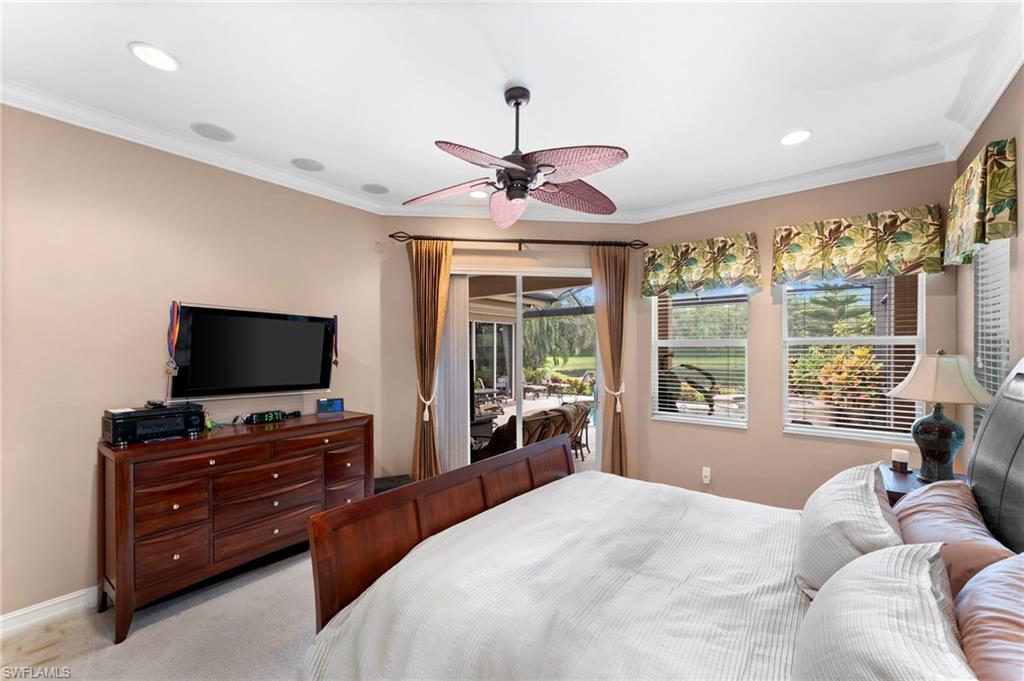 6155 Dogleg Drive Naples, FL 34113 - Photo 12 of 36 a bedroom with a bed and a flat screen tv