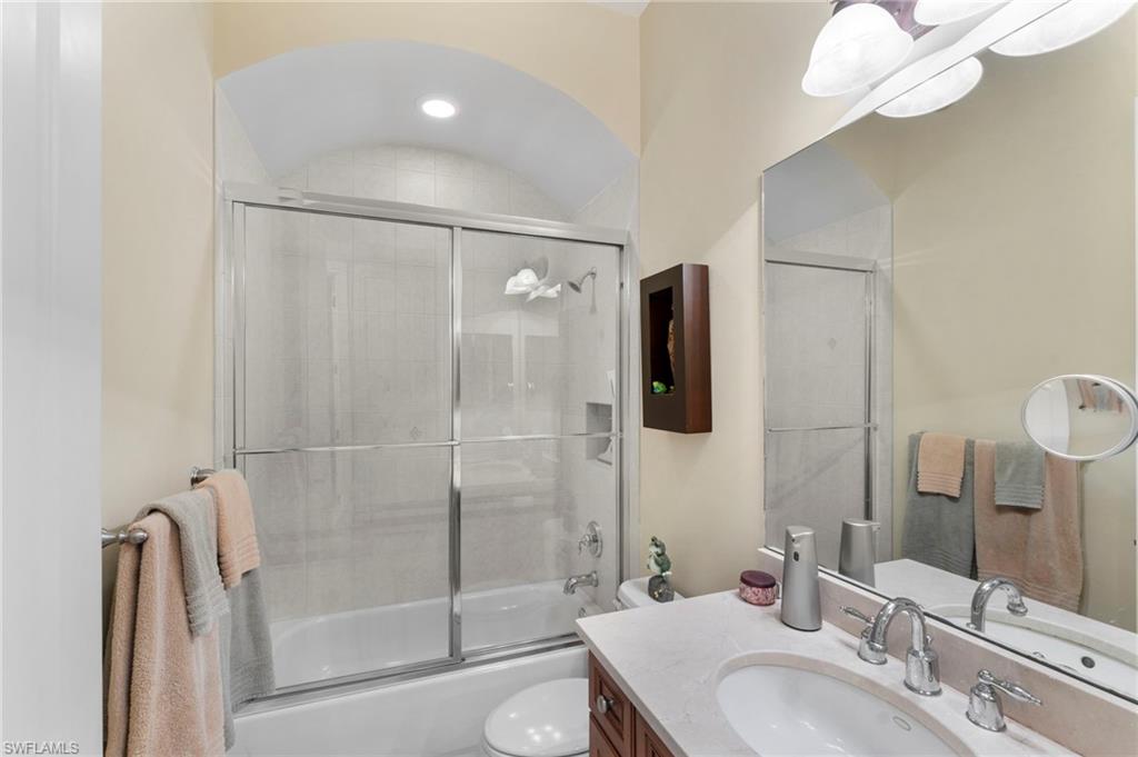 6155 Dogleg Drive Naples, FL 34113 - Photo 17 of 36 a bathroom with a granite countertop sink a toilet and shower