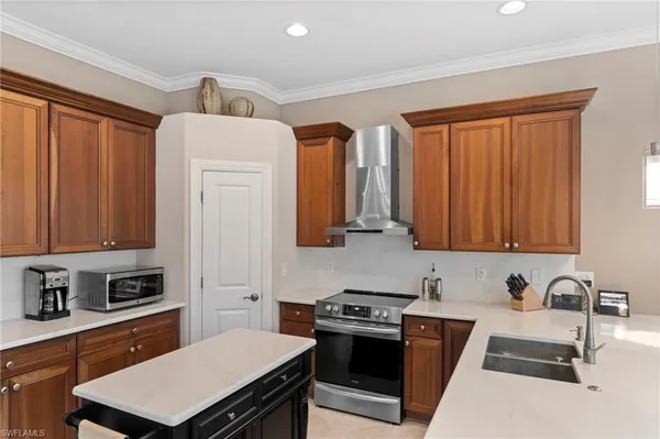 a kitchen with stainless steel appliances a stove a sink dishwasher and wooden cabinets