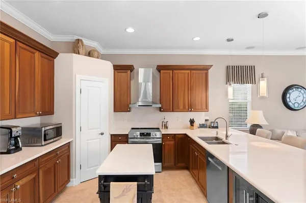 a kitchen with a sink a stove and a refrigerator