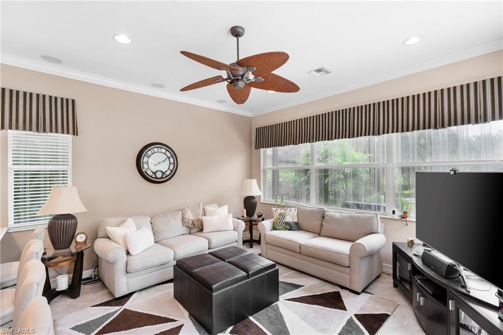 6155 Dogleg Drive Naples, FL 34113 - Photo 23 of 36 a living room with furniture and a large window