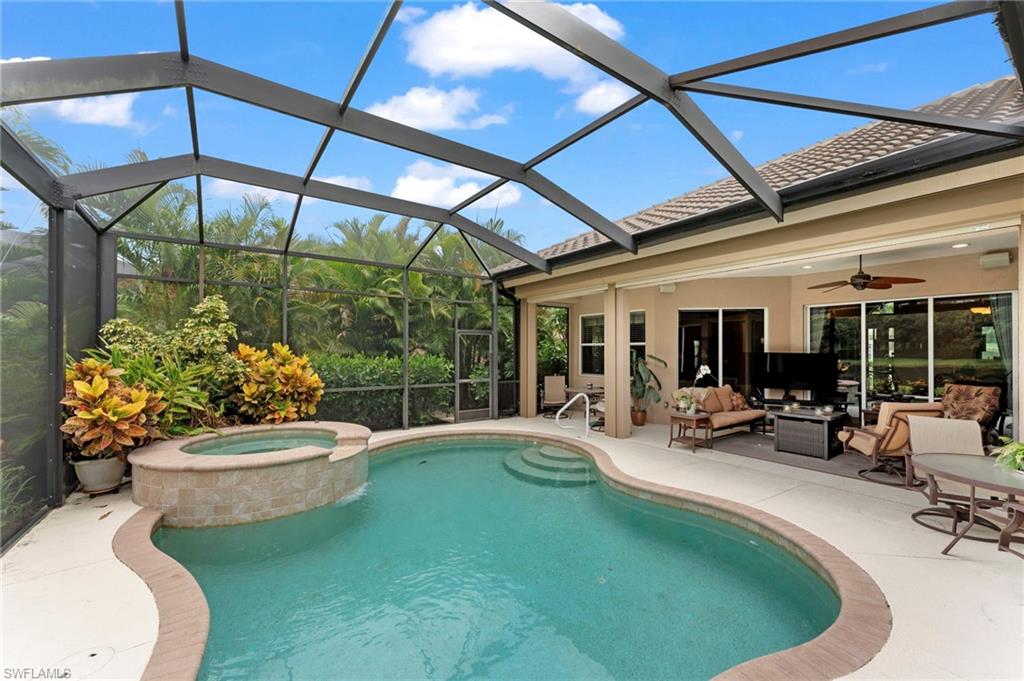 6155 Dogleg Drive Naples, FL 34113 - Photo 28 of 36 a view of a patio with chairs and a small yard