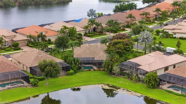 an aerial view of a house with garden space and lake view