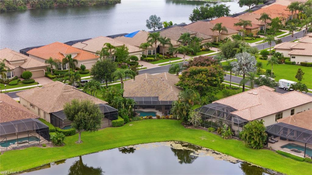 6155 Dogleg Drive Naples, FL 34113 - Photo 30 of 36 an aerial view of a house with garden space and lake view