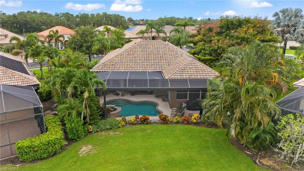 6155 Dogleg Drive Naples, FL 34113 - Photo 31 of 36 a front view of a house with garden