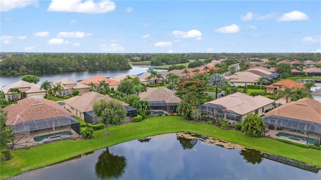 6155 Dogleg Drive Naples, FL 34113 - Photo 33 of 36 an aerial view of a house with garden space and lake view in back
