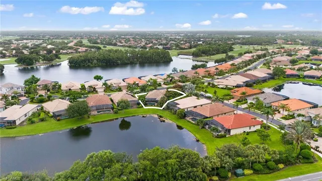 an aerial view of a houses with a lake view