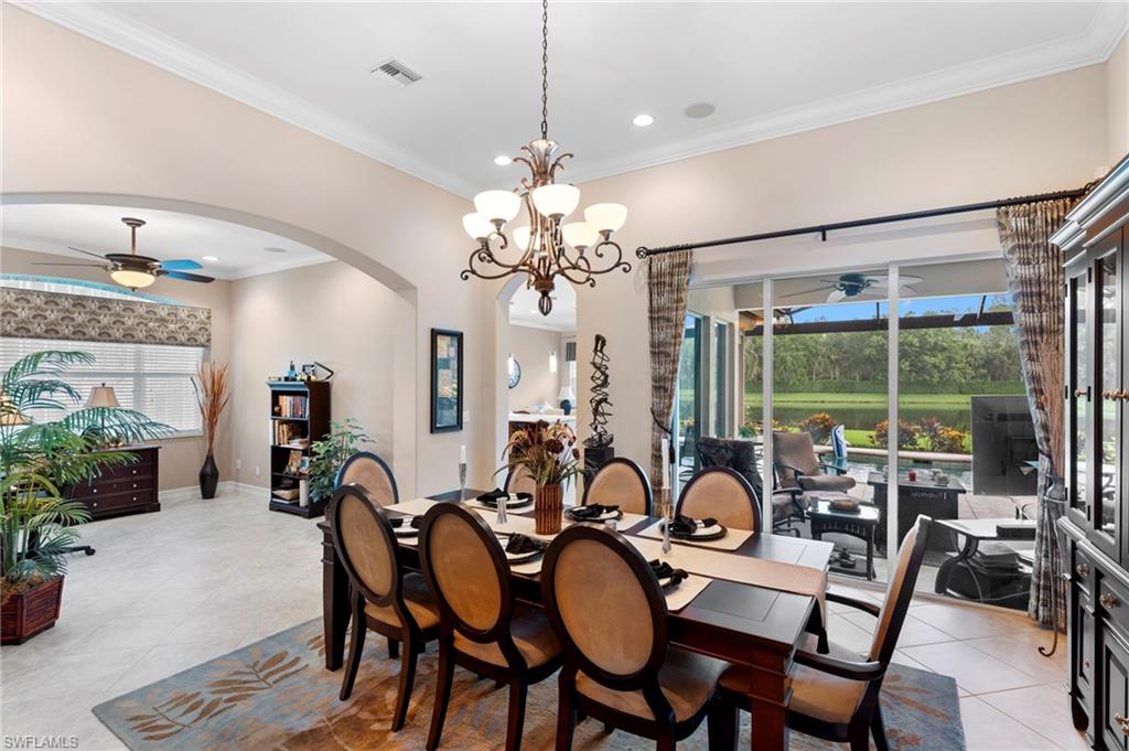 6155 Dogleg Drive Naples, FL 34113 - Photo 7 of 36 a dining room with furniture a chandelier and window