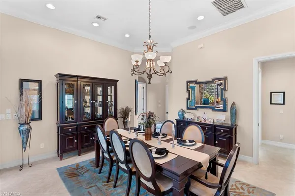 a view of a dining room with furniture and chandelier