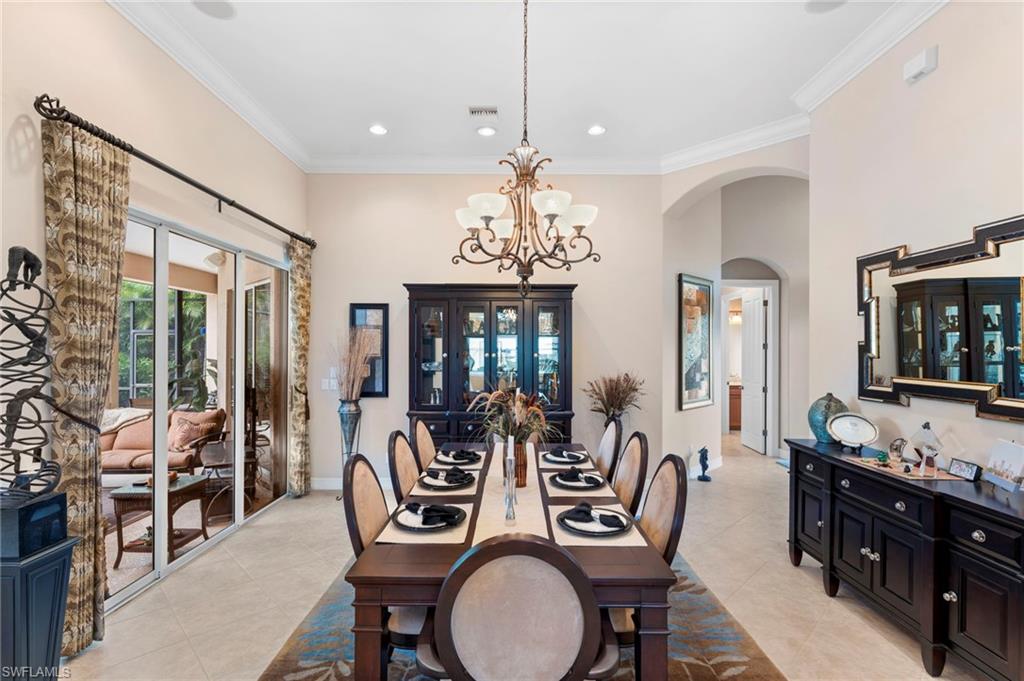 6155 Dogleg Drive Naples, FL 34113 - Photo 9 of 36 a view of a dining room with furniture large window and wooden floor