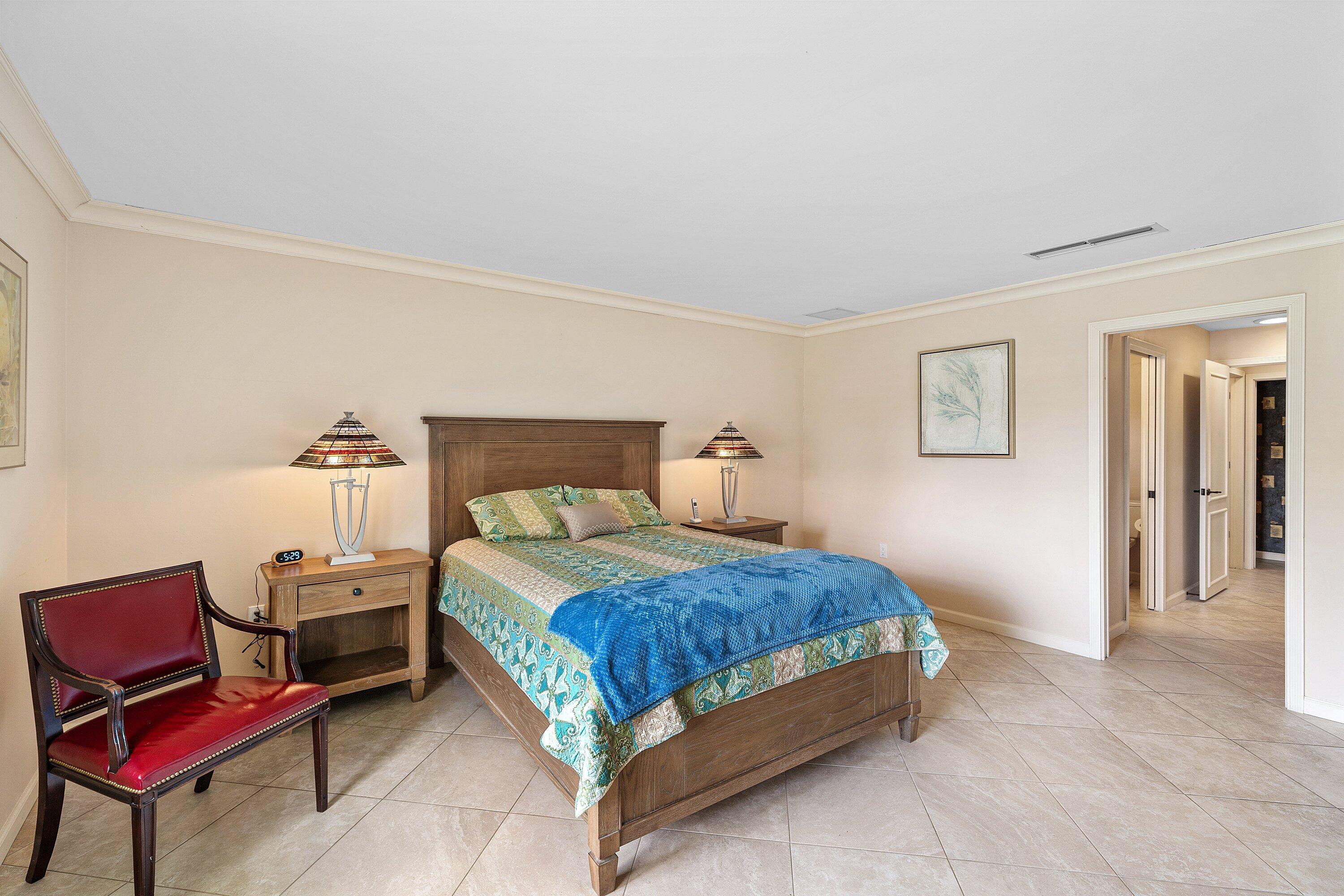 4365 Shell Drake Lane Boynton Beach, FL 33436 - Photo 19 of 56 a bedroom with a bed and a chair