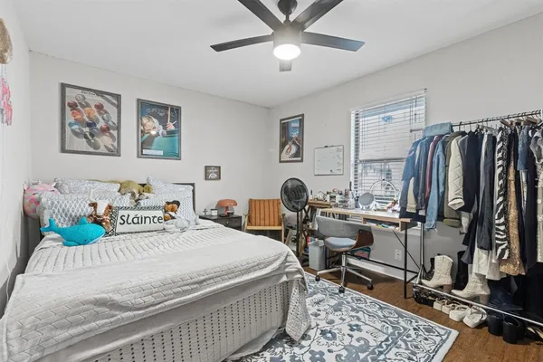 a bedroom with a bed a desk and chair