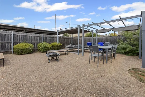 a view of a patio with a table and chairs