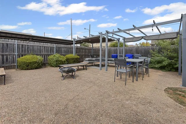 a view of a patio with a table and chairs