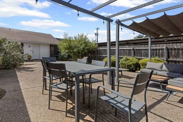 a view of a backyard with furniture and a garden