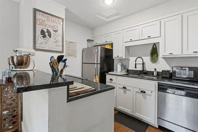 a kitchen with appliances cabinets and a sink