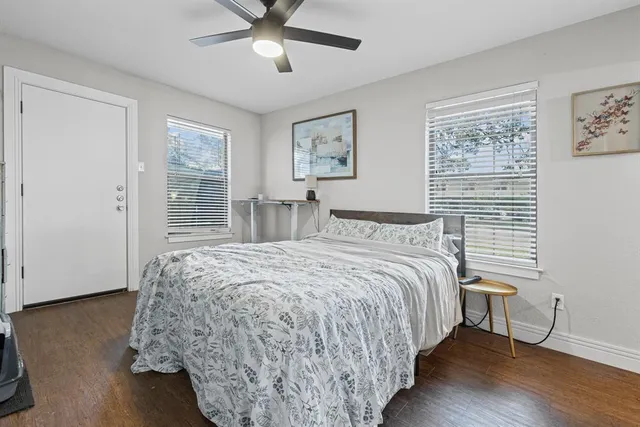 a bedroom with bed and wooden floor