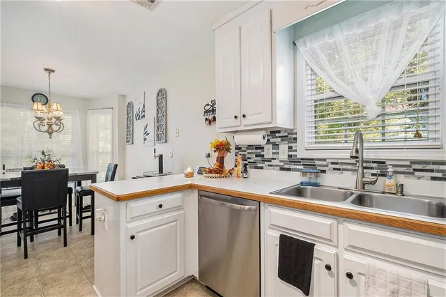 a kitchen with a sink cabinets and window