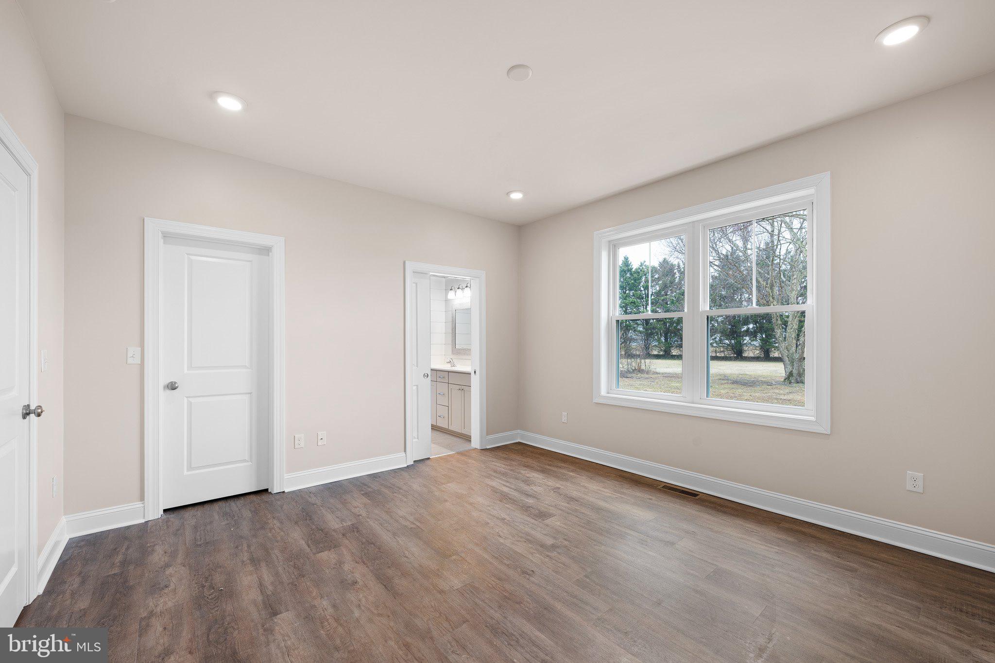 4438 Paradise Alley Road Felton, DE 19943 - Photo 13 of 30 a view of an empty room with wooden floor and a window