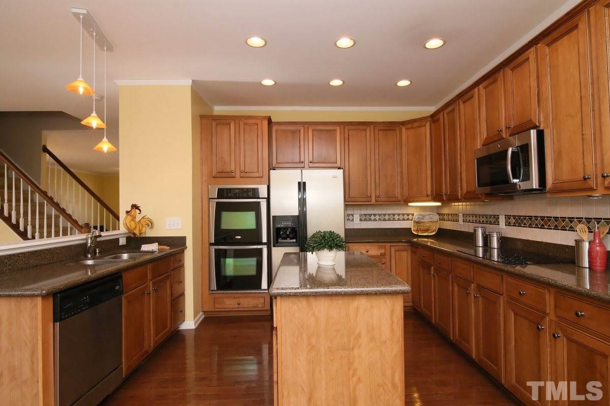 832 Seastone Street Raleigh, NC 27603 - Photo 2 of 25 a kitchen with stainless steel appliances granite countertop a stove a sink and a refrigerator