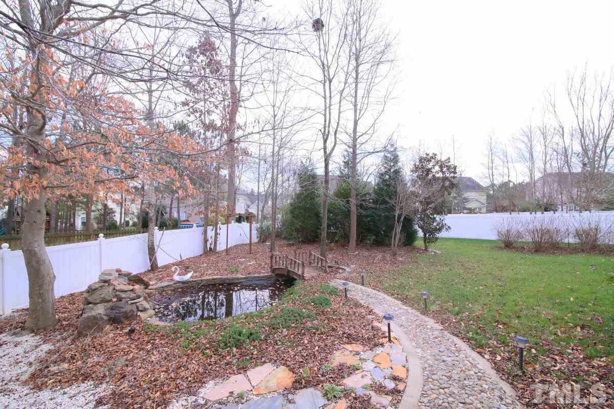 832 Seastone Street Raleigh, NC 27603 - Photo 12 of 25 a view of a backyard with trees