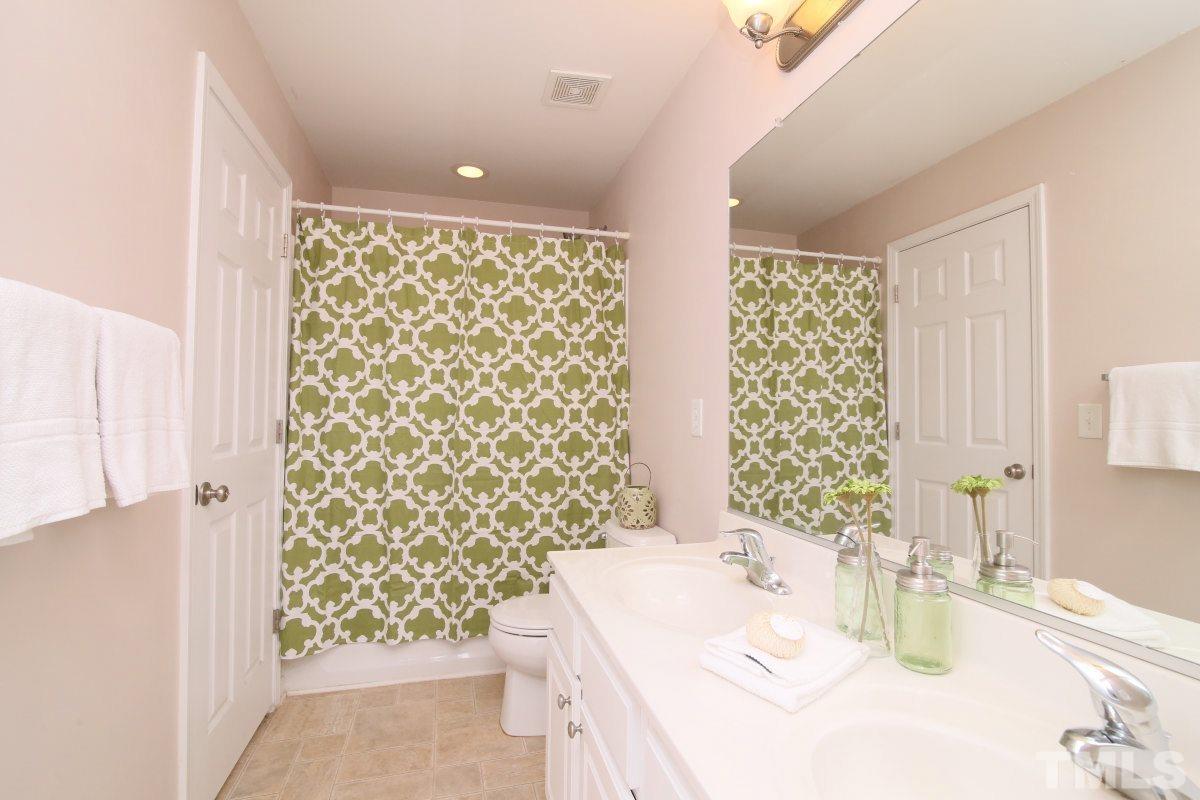 832 Seastone Street Raleigh, NC 27603 - Photo 21 of 25 a bathroom with a sink and a mirror