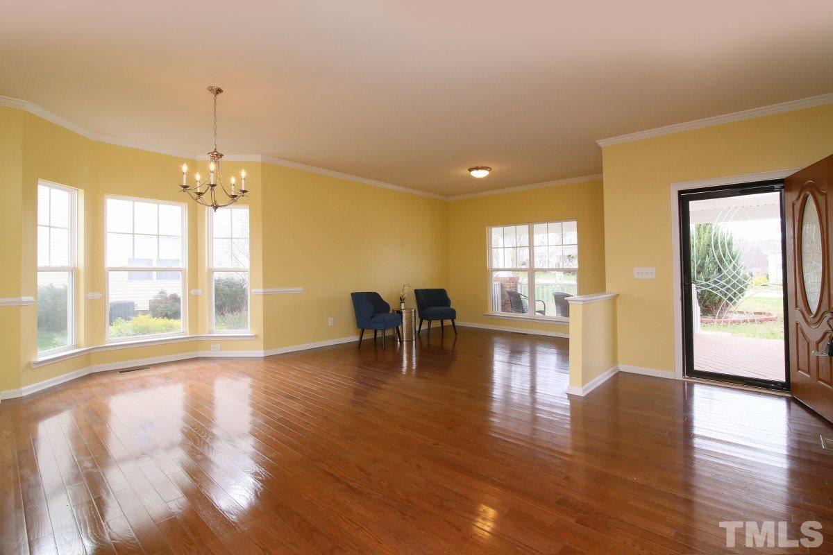 832 Seastone Street Raleigh, NC 27603 - Photo 4 of 25 a view of a livingroom with furniture wooden floor and a window