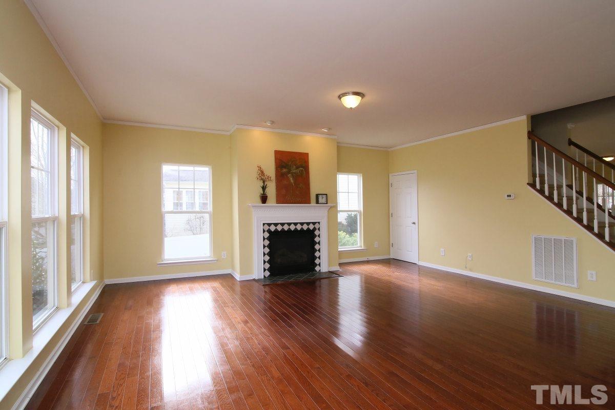 832 Seastone Street Raleigh, NC 27603 - Photo 5 of 25 wooden floor fireplace and windows in an empty room