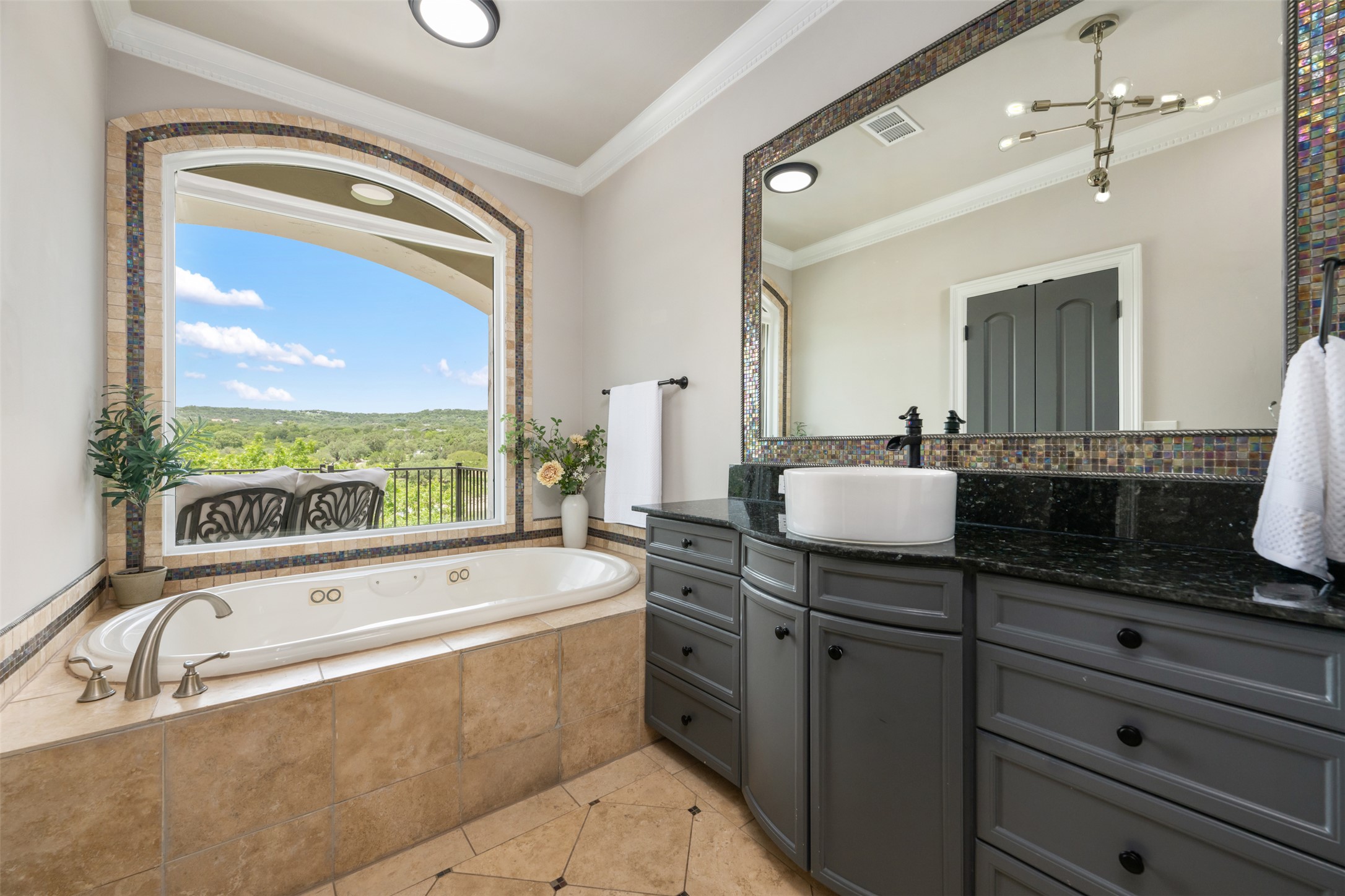 10716 Beach Road Leander, TX 78641 - Photo 24 of 39 Bathroom featuring vanity, a bath, tile patterned flooring, ornamental molding, and a chandelier