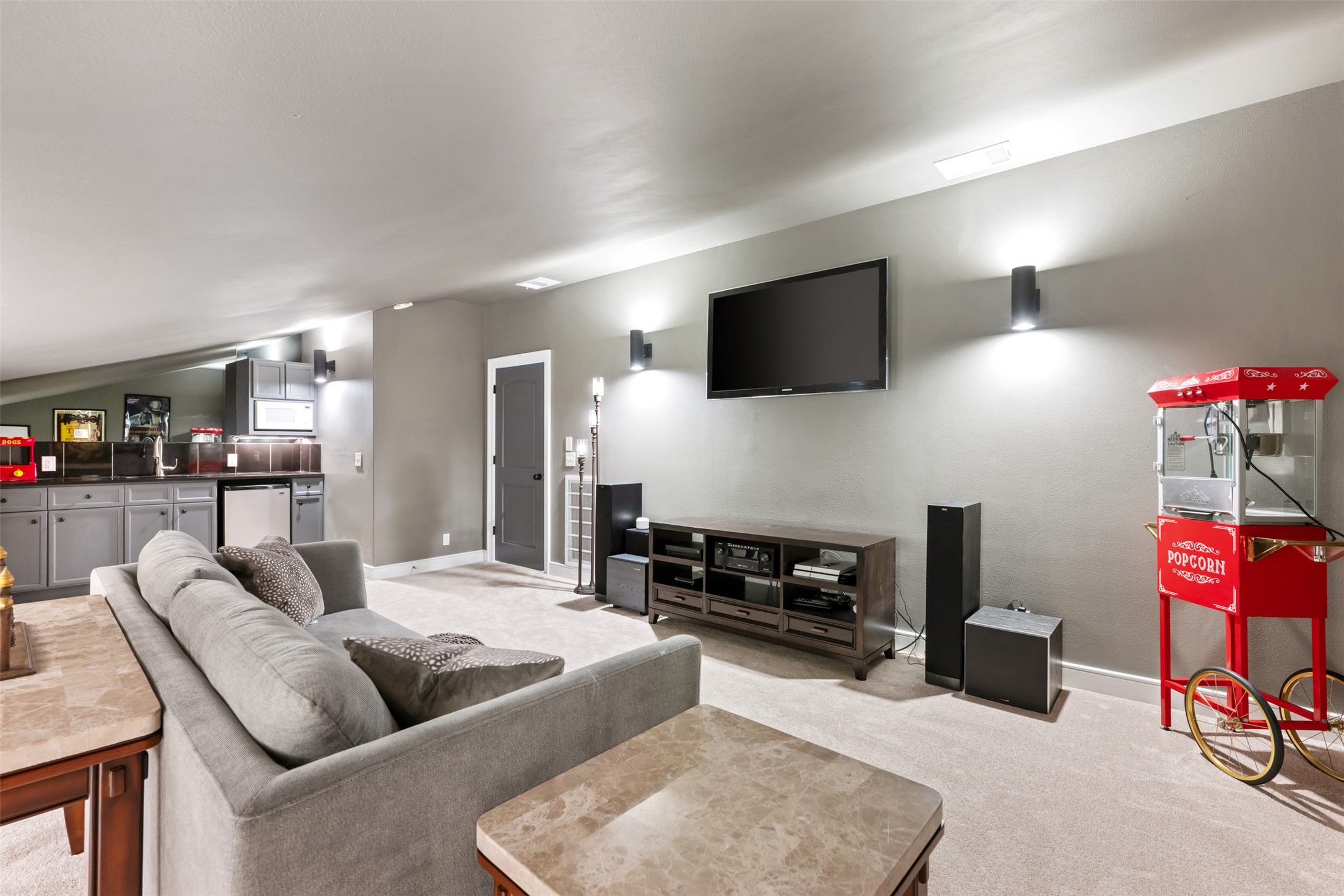 10716 Beach Road Leander, TX 78641 - Photo 25 of 39 Living area with bar with sink, light colored carpet, and lofted ceiling