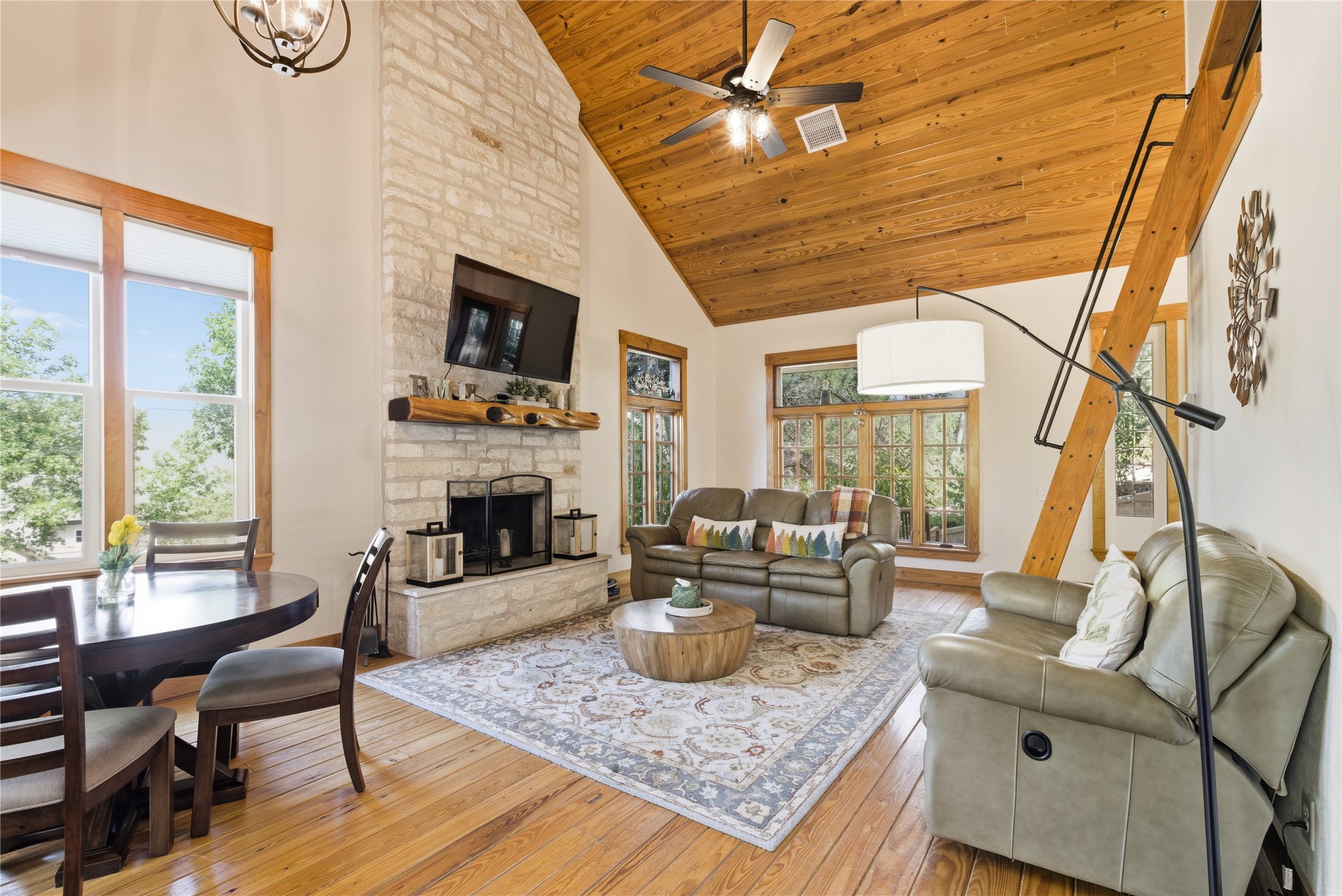 10716 Beach Road Leander, TX 78641 - Photo 34 of 39 Living area with high vaulted ceiling, light wood finished floors, healthy amount of natural light, a fireplace, and wood ceiling