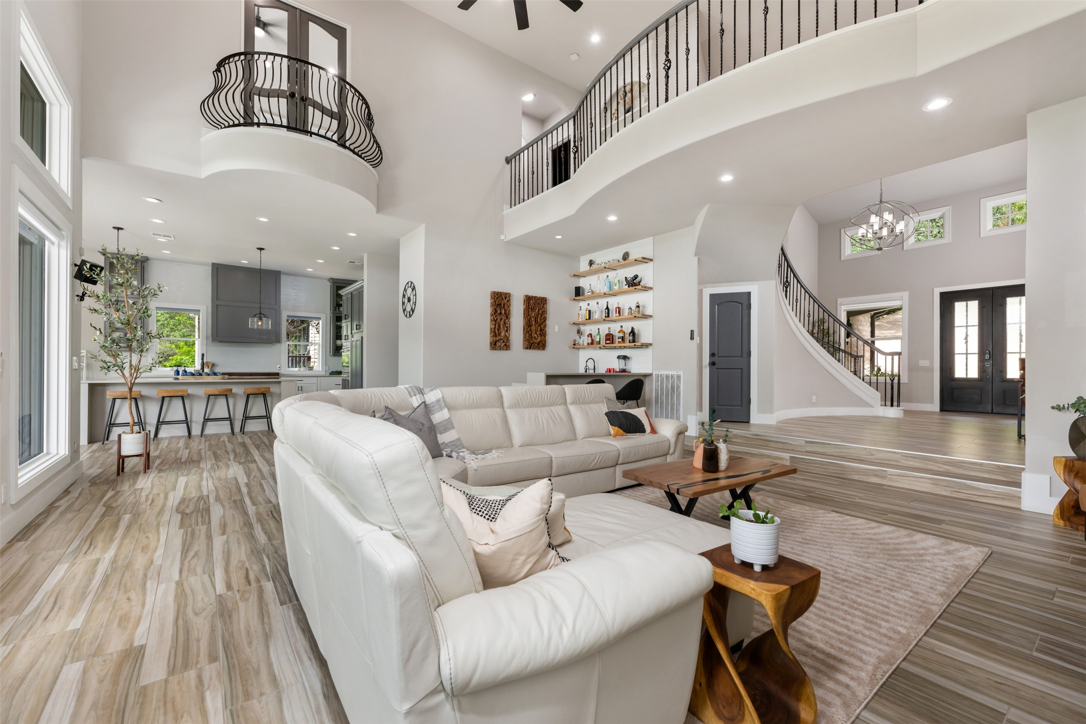 10716 Beach Road Leander, TX 78641 - Photo 5 of 39 Living room featuring a high ceiling, stairway, a chandelier, light wood-type flooring, and french doors