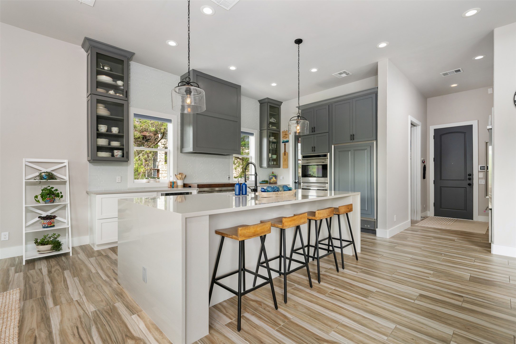 10716 Beach Road Leander, TX 78641 - Photo 9 of 39 Kitchen with light countertops, a breakfast bar area, light wood-type flooring, a kitchen island with sink, and recessed lighting