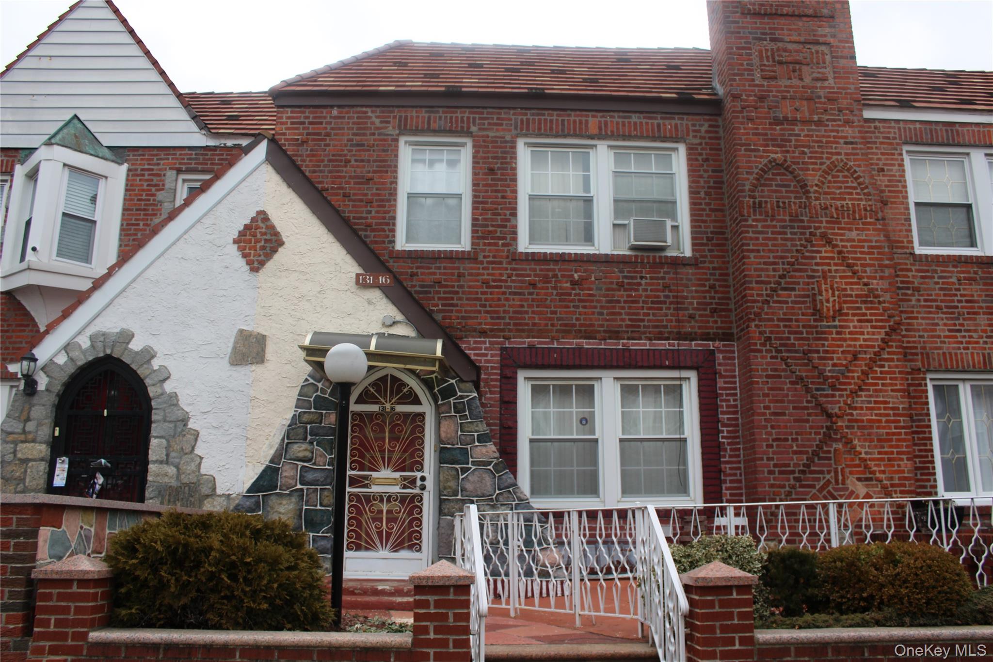 a view of a brick house with large windows