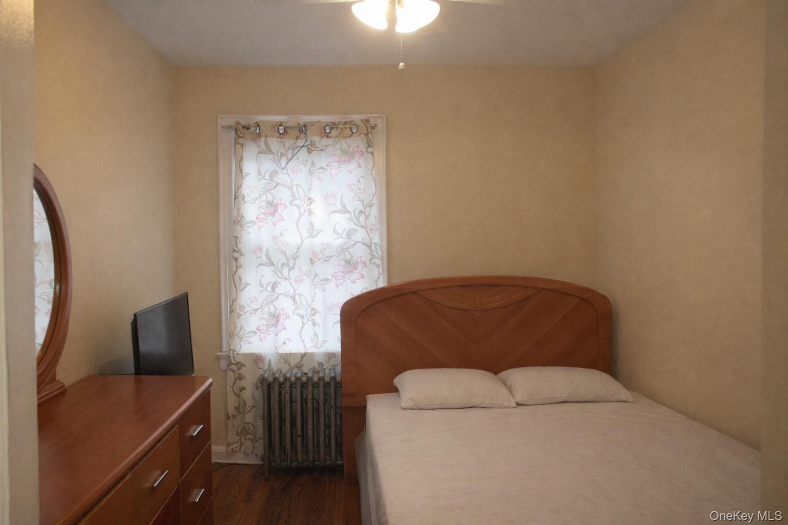 131-16 226th Street Queens, NY 11413 - Photo 5 of 12 a living room with furniture and a window