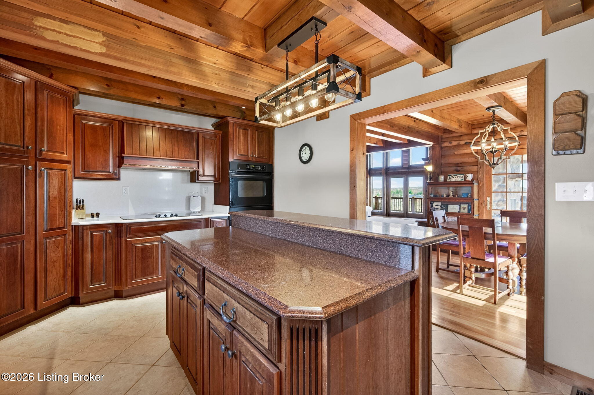 771 Mud Splash Road Elizabethtown, KY 42701 - Photo 38 of 85 A striking pendant fixture hangs above the island, feeling right at home beneath the beamed ceiling