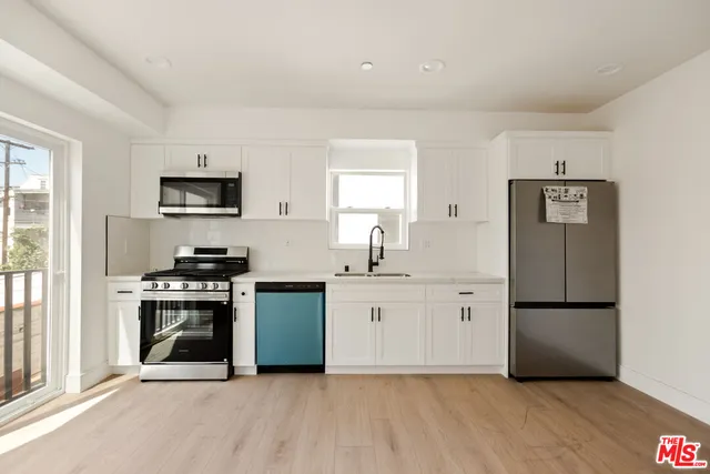 a kitchen with a sink stove and refrigerator