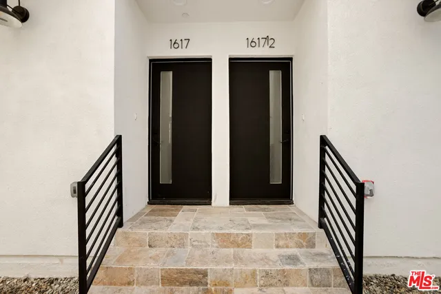 a view of a hallway with wooden floor and closet