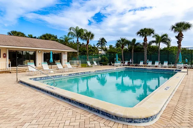 a view of a house with a big yard and large trees