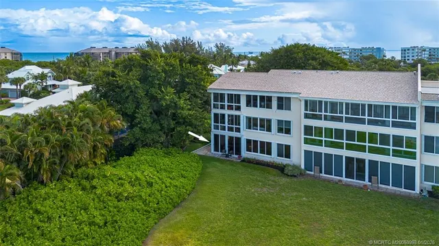 an aerial view of a house with a ocean view